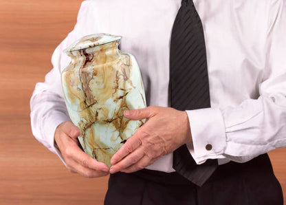 A man holding handmade Monalisa Cremation Urn